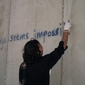 spraying Mandela quote on the wall.jpg