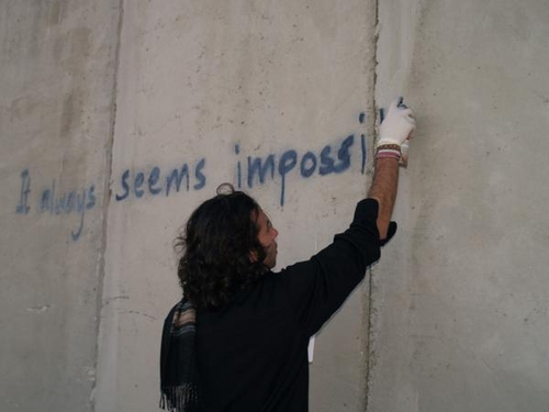 spraying Mandela quote on the wall.jpg